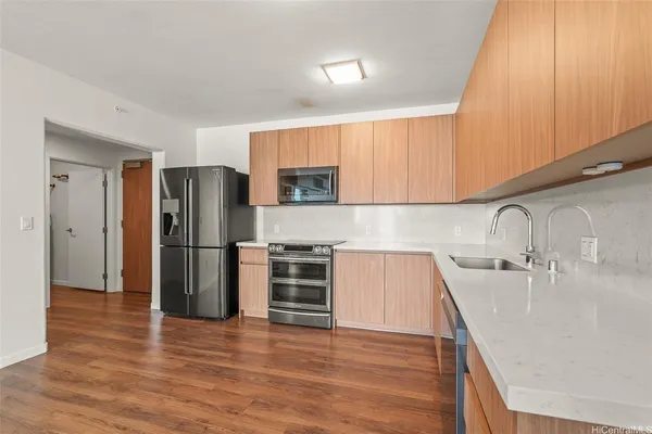 a kitchen with a refrigerator sink and cabinets