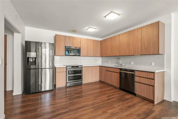 a kitchen with a refrigerator and a stove top oven