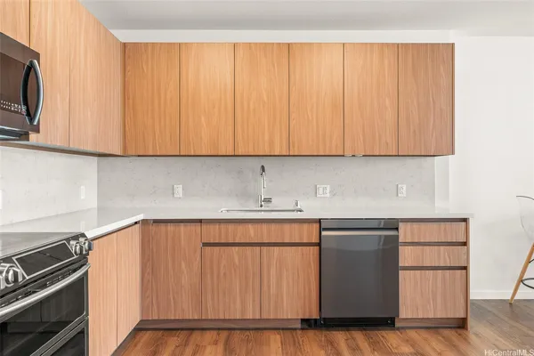 a kitchen with a sink a microwave and cabinets
