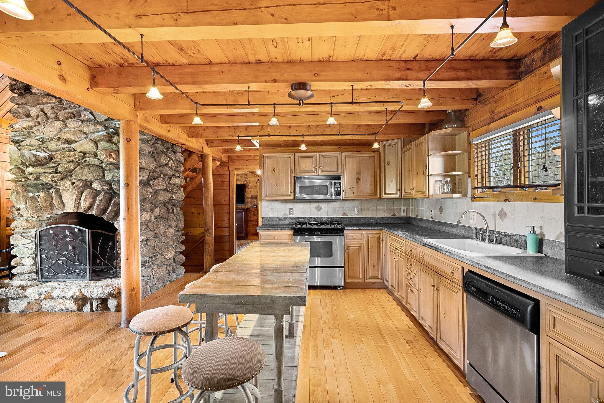 18837 Trinity Church Road Purcellville, VA 20132 - Photo 19 of 73 a large kitchen with stainless steel appliances kitchen island granite countertop a sink and cabinets