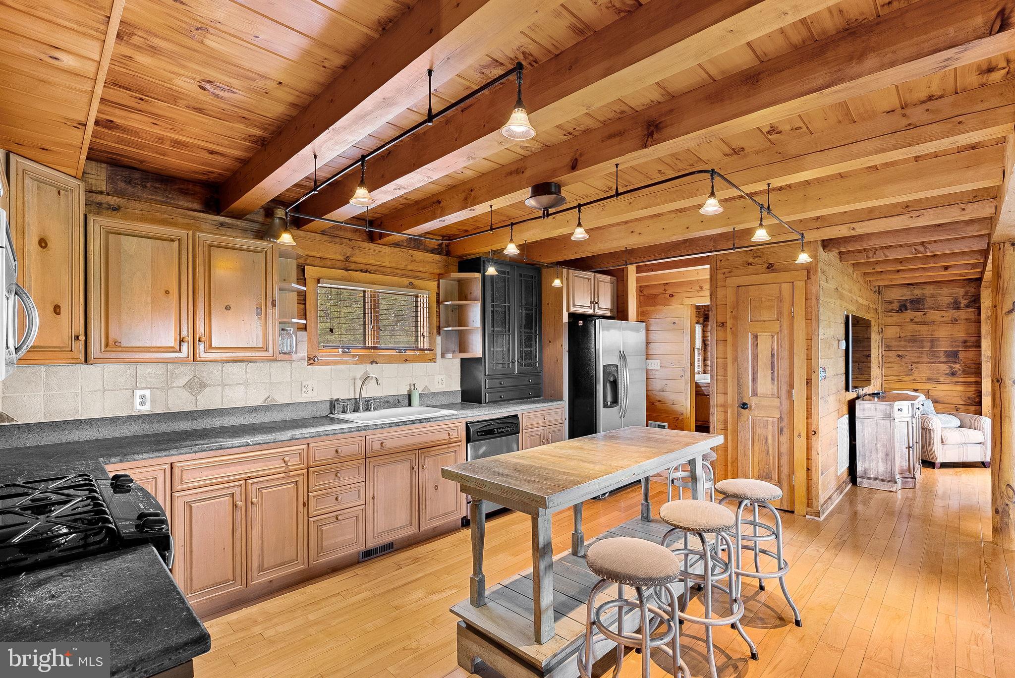18837 Trinity Church Road Purcellville, VA 20132 - Photo 23 of 73 a kitchen with a sink and chairs