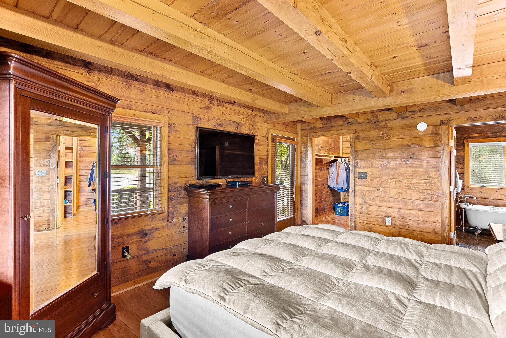 18837 Trinity Church Road Purcellville, VA 20132 - Photo 26 of 73 a bedroom with a bed and a flat screen tv
