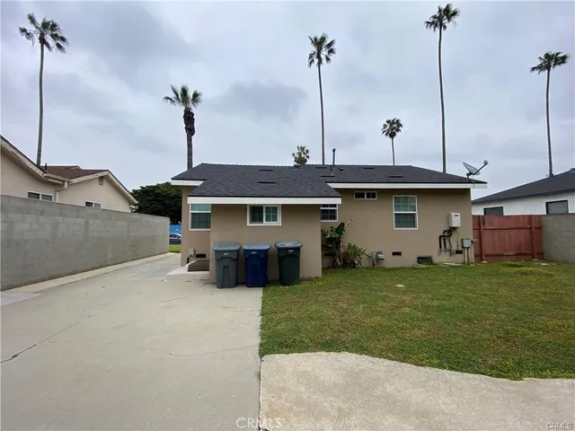 a front view of a house with a garden and plants