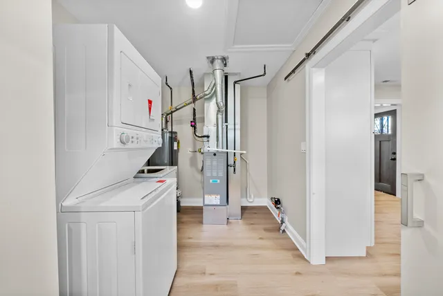 a view of a hallway with wooden floor and entryway