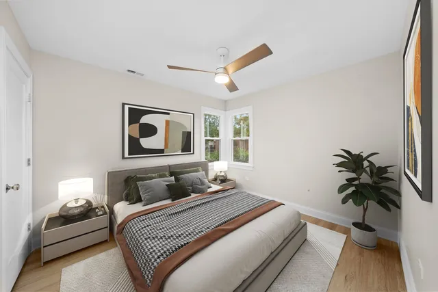 a bedroom with a bed and wooden floor