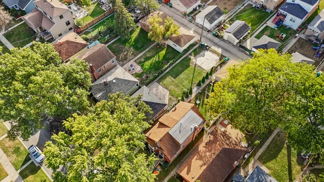 an aerial view of a house with a yard