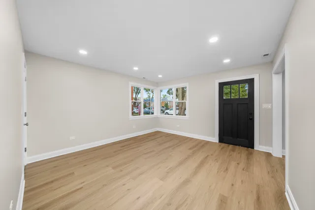 wooden floor in a hall with an empty room