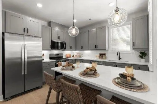 a kitchen with a sink a stove and chairs