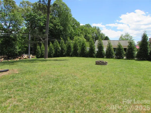 a view of a field with trees in the background