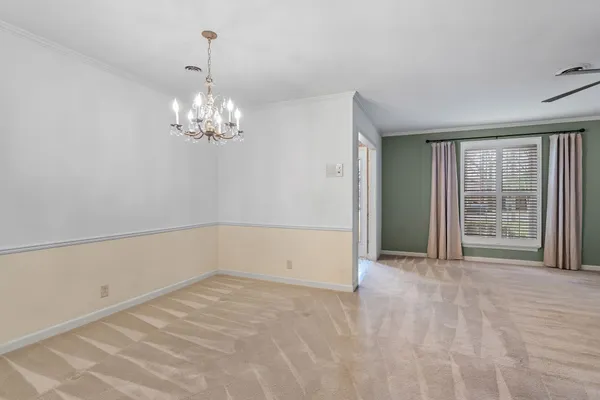 a view of a livingroom with a fireplace and window