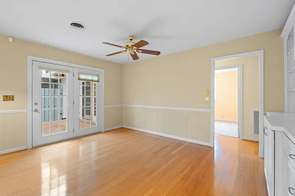wooden floor in an empty room with a window