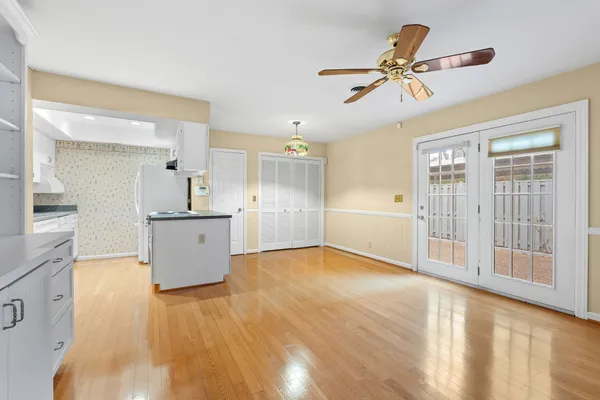 a kitchen with granite countertop white cabinets and window