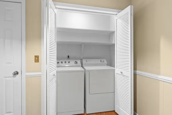 a kitchen with kitchen island a stove a sink cabinets and a refrigerator