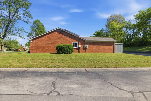 a front view of house with yard and green space