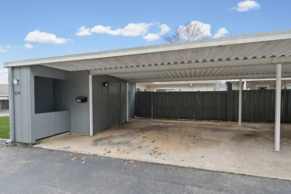 a view of a back yard with wooden walls