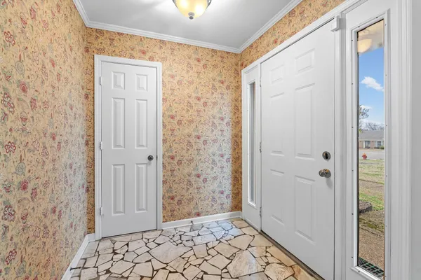 a view of a hallway with wooden floor and a fireplace