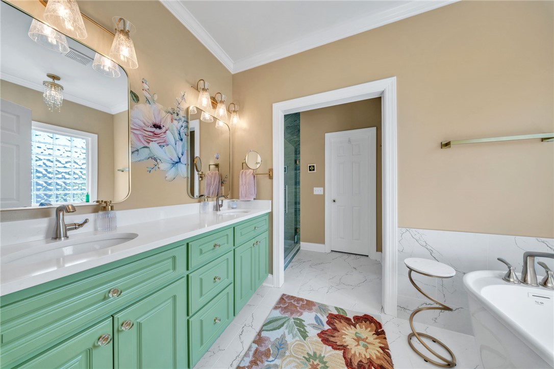 648 Mountain View Road Williamston, SC 29697 - Photo 20 of 42 A vibrant bathroom features dual vanities and a spacious shower, with bright lighting illuminating every detail.
