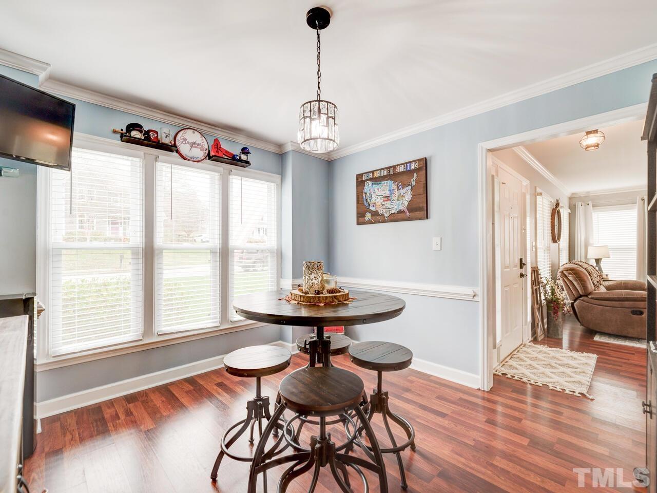 4209 Willow Lake Road Raleigh, NC 27616 - Photo 20 of 54 a view of a dining room with furniture window and wooden floor