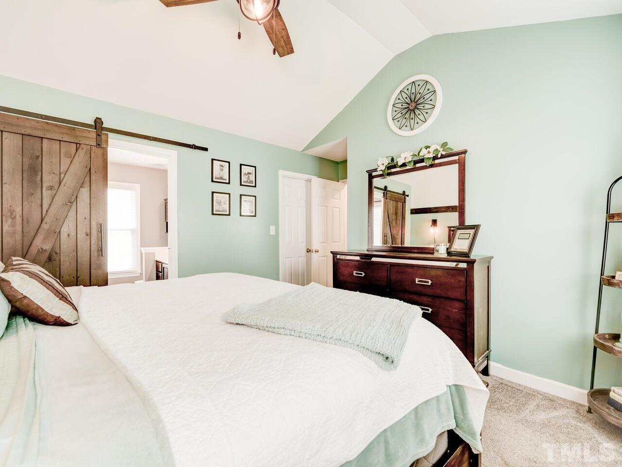 4209 Willow Lake Road Raleigh, NC 27616 - Photo 26 of 54 a bedroom with a bed and a chandelier