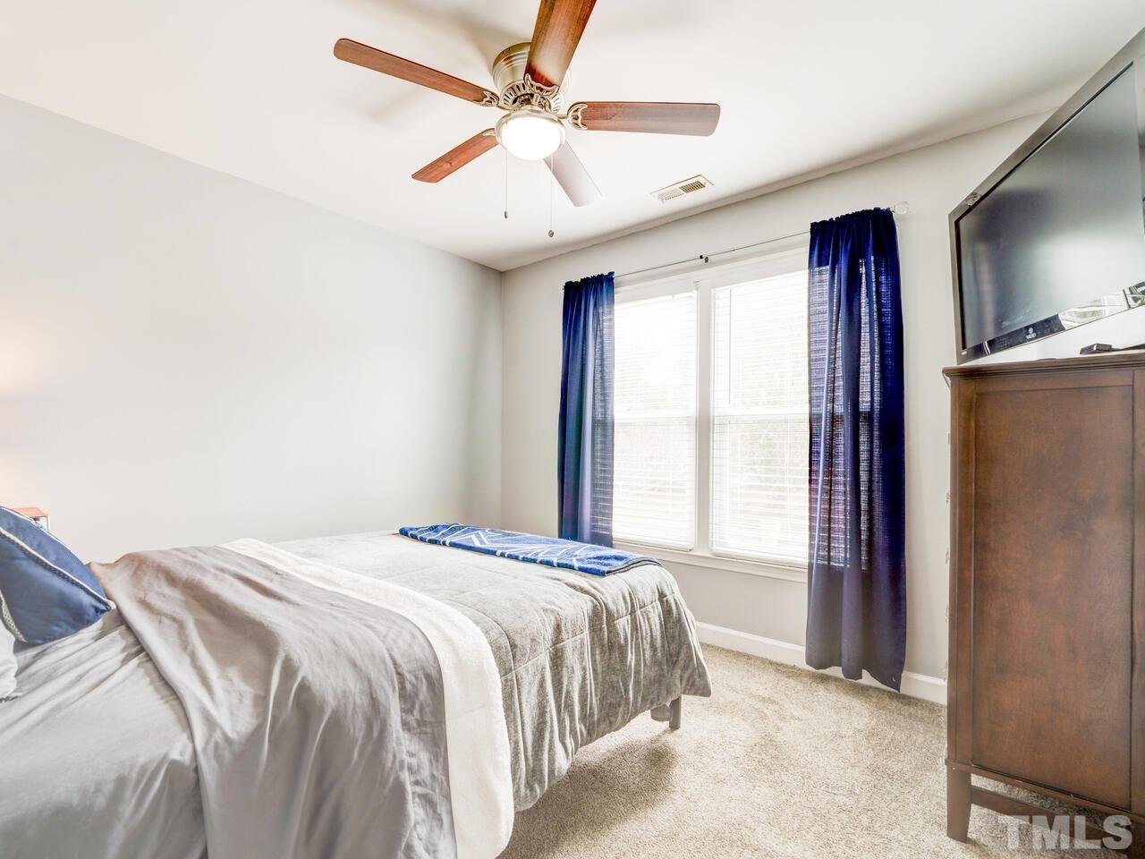 4209 Willow Lake Road Raleigh, NC 27616 - Photo 38 of 54 a bedroom with a large bed and a large window