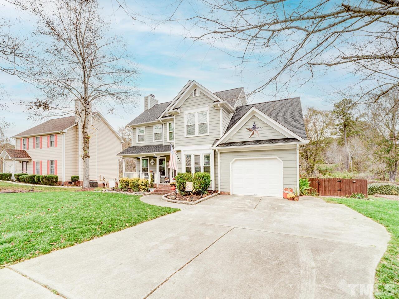 4209 Willow Lake Road Raleigh, NC 27616 - Photo 50 of 54 a view of a white house with a big yard and large trees