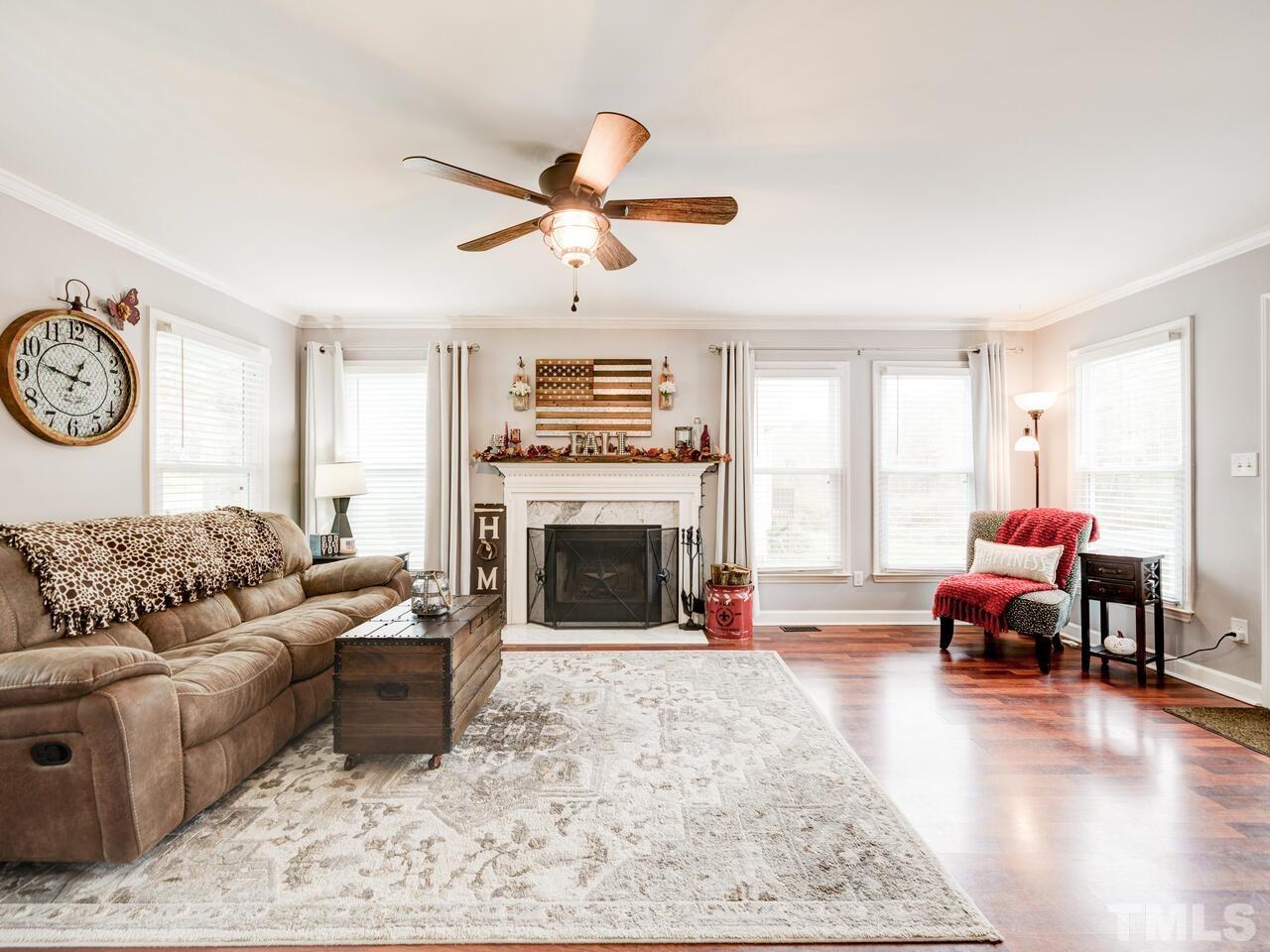 4209 Willow Lake Road Raleigh, NC 27616 - Photo 6 of 54 a living room with furniture a fireplace and a large window