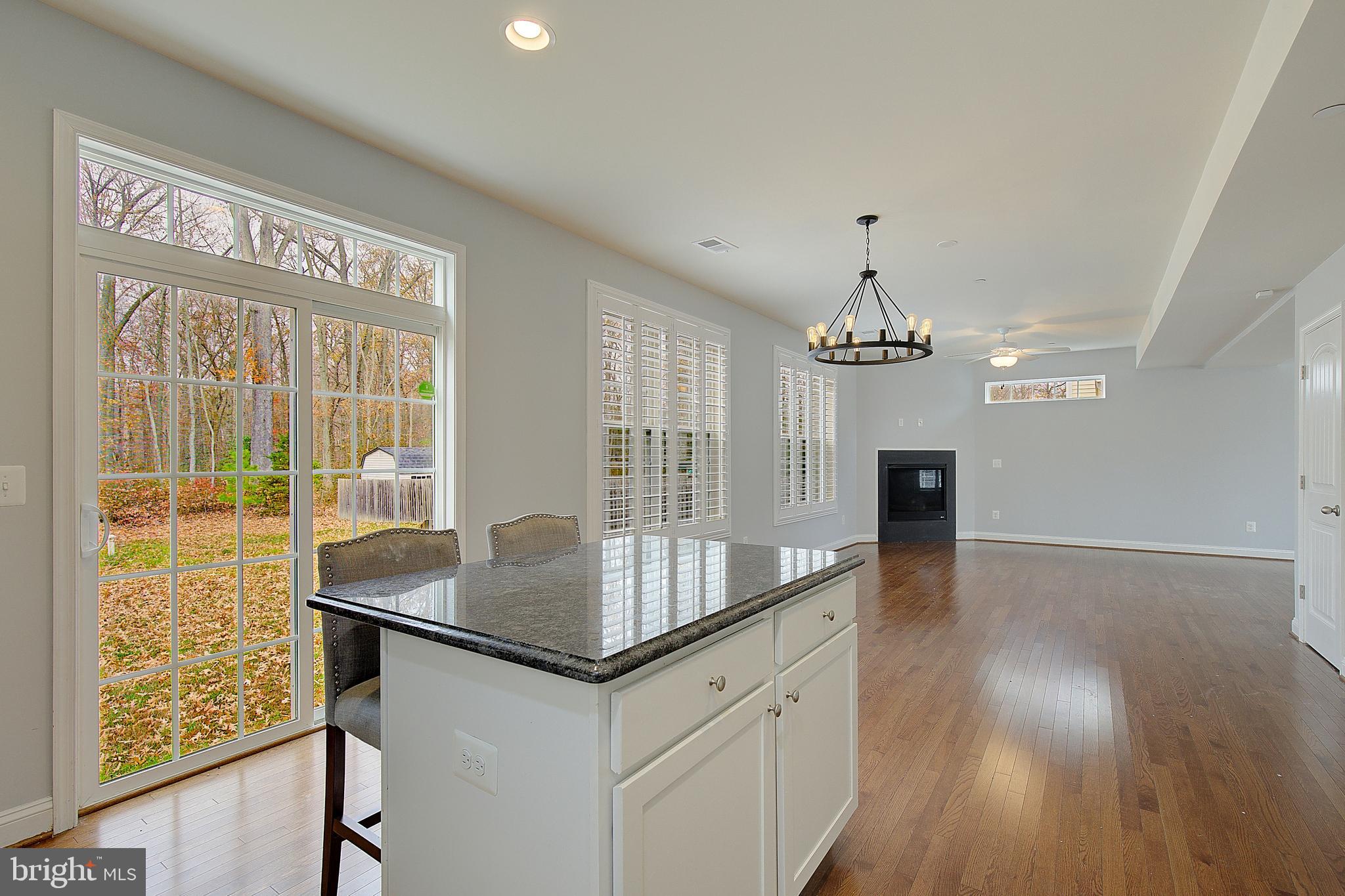 5952 Tyler Road Deale, MD 20751 - Photo 11 of 33 a hallway with wooden floor and chandelier