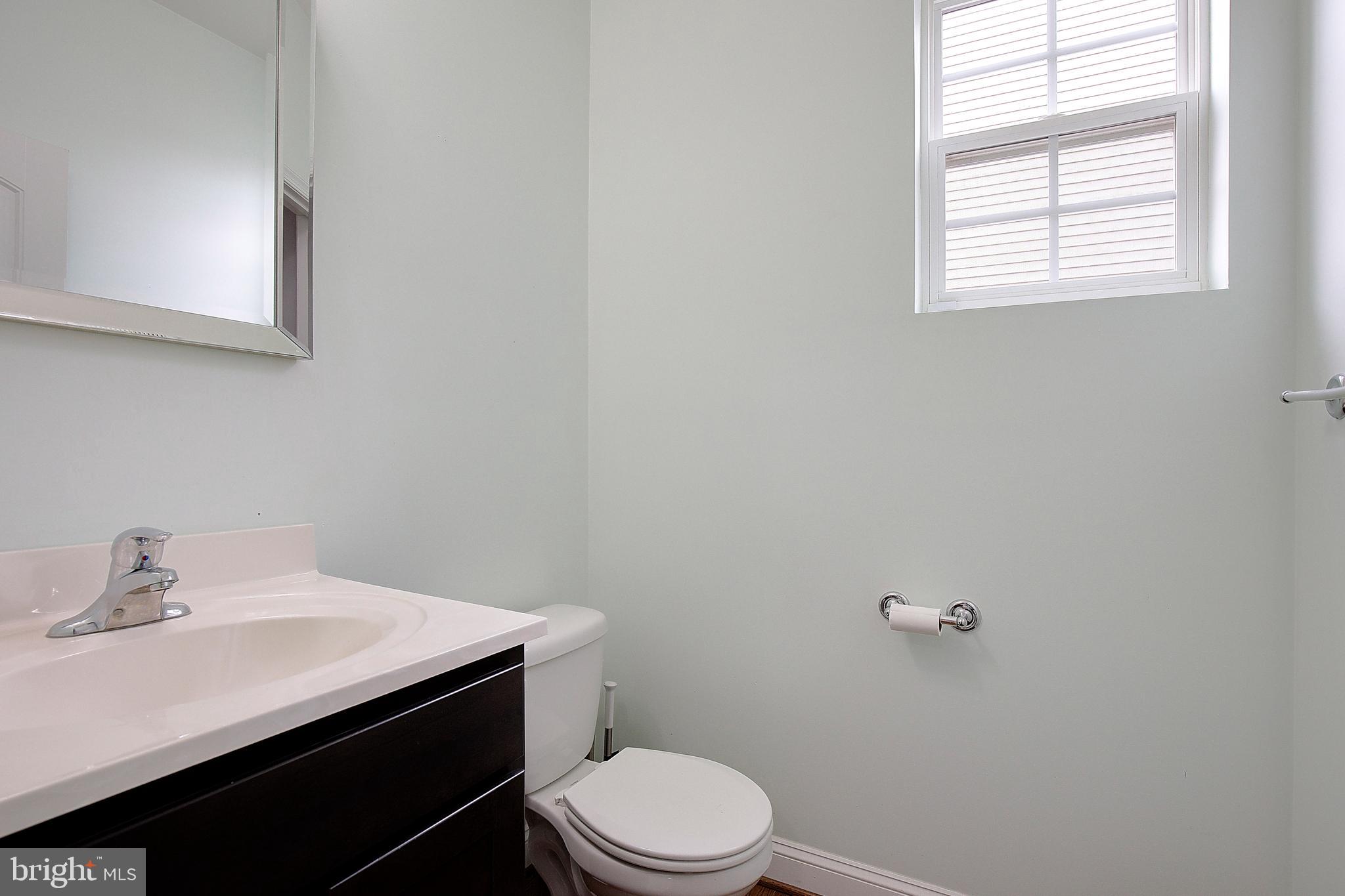5952 Tyler Road Deale, MD 20751 - Photo 13 of 33 a bathroom with a sink a toilet and a window