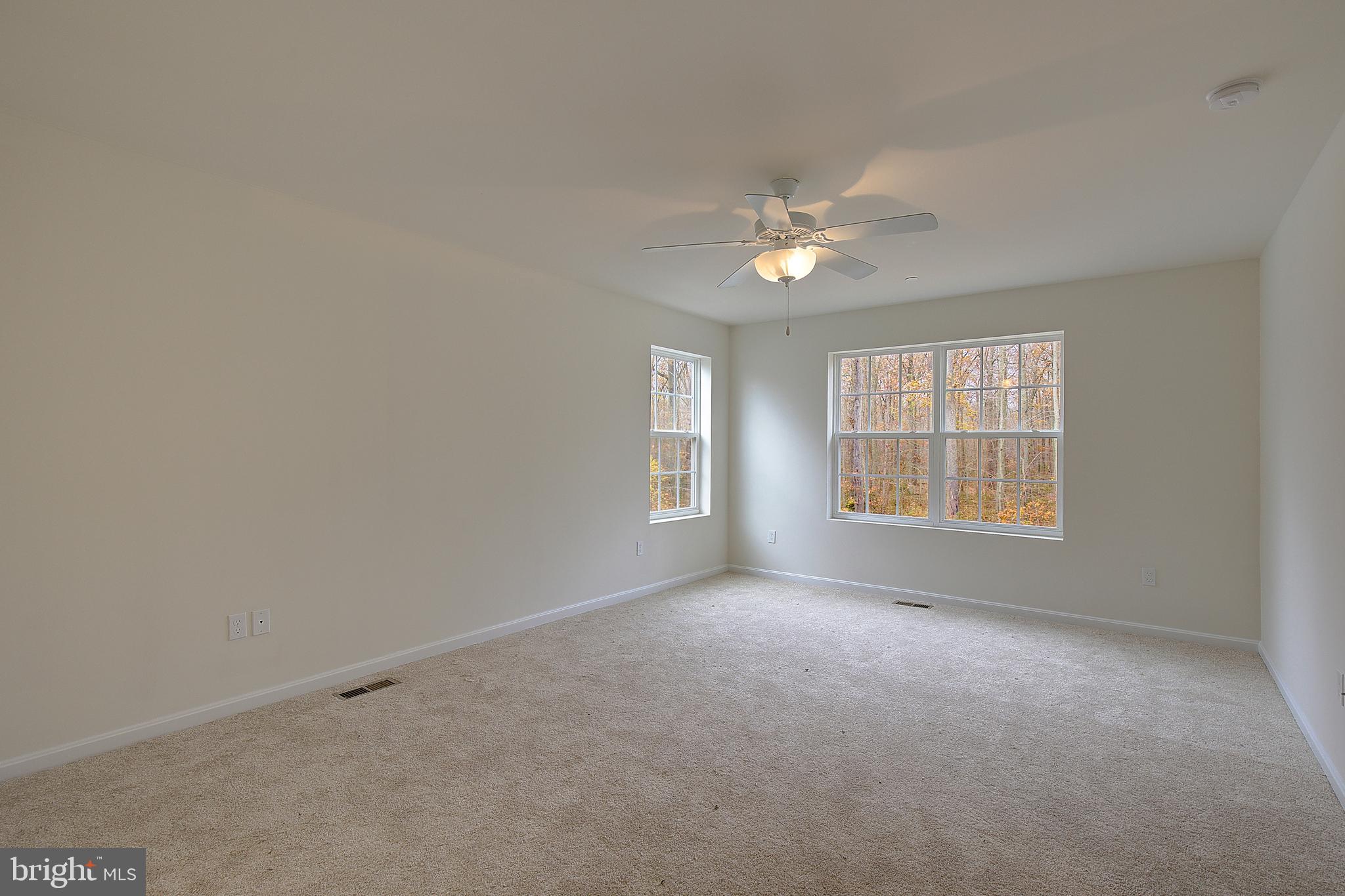 5952 Tyler Road Deale, MD 20751 - Photo 20 of 33 an empty room with windows and ceiling fan