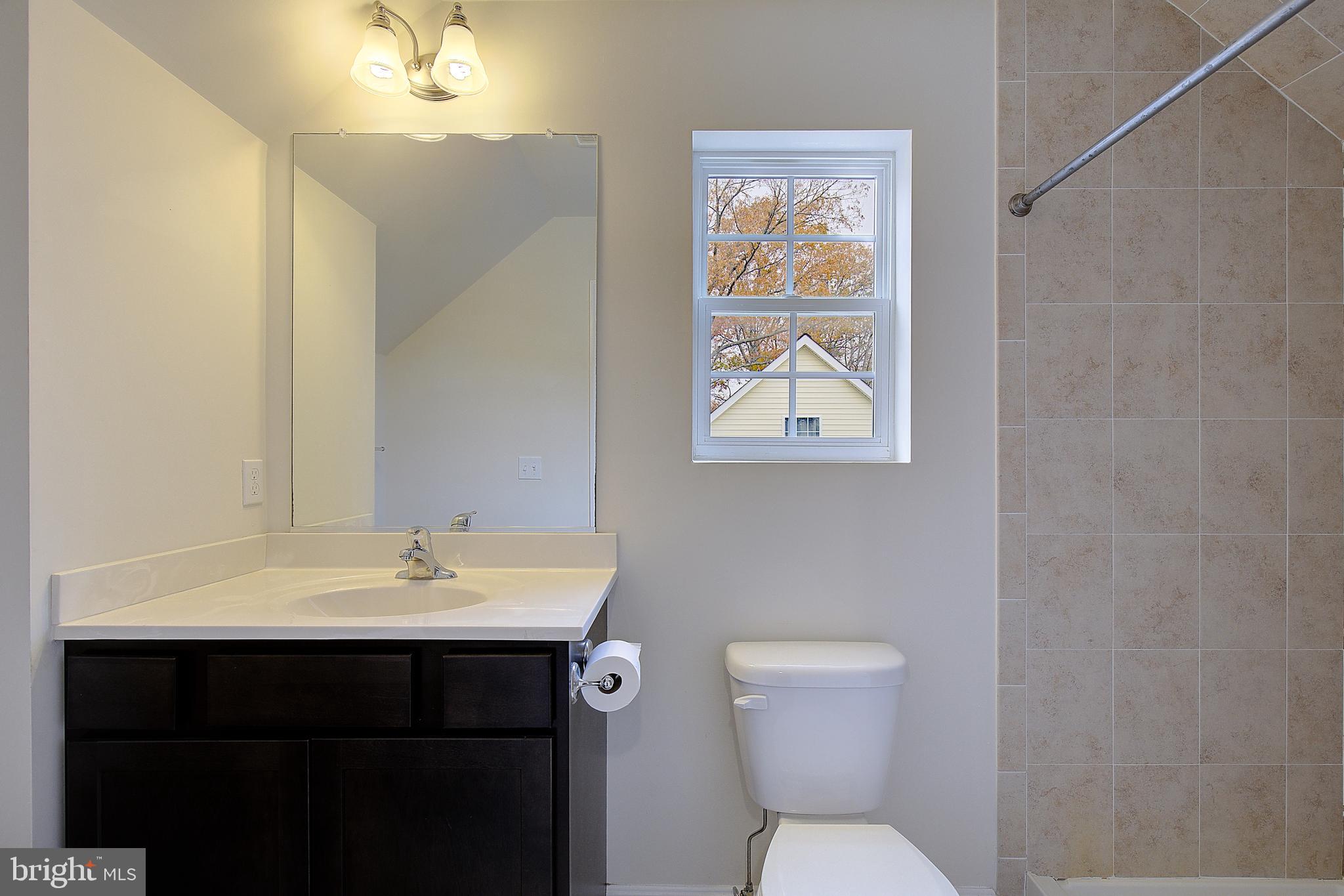 5952 Tyler Road Deale, MD 20751 - Photo 28 of 33 a bathroom with a toilet sink and mirror