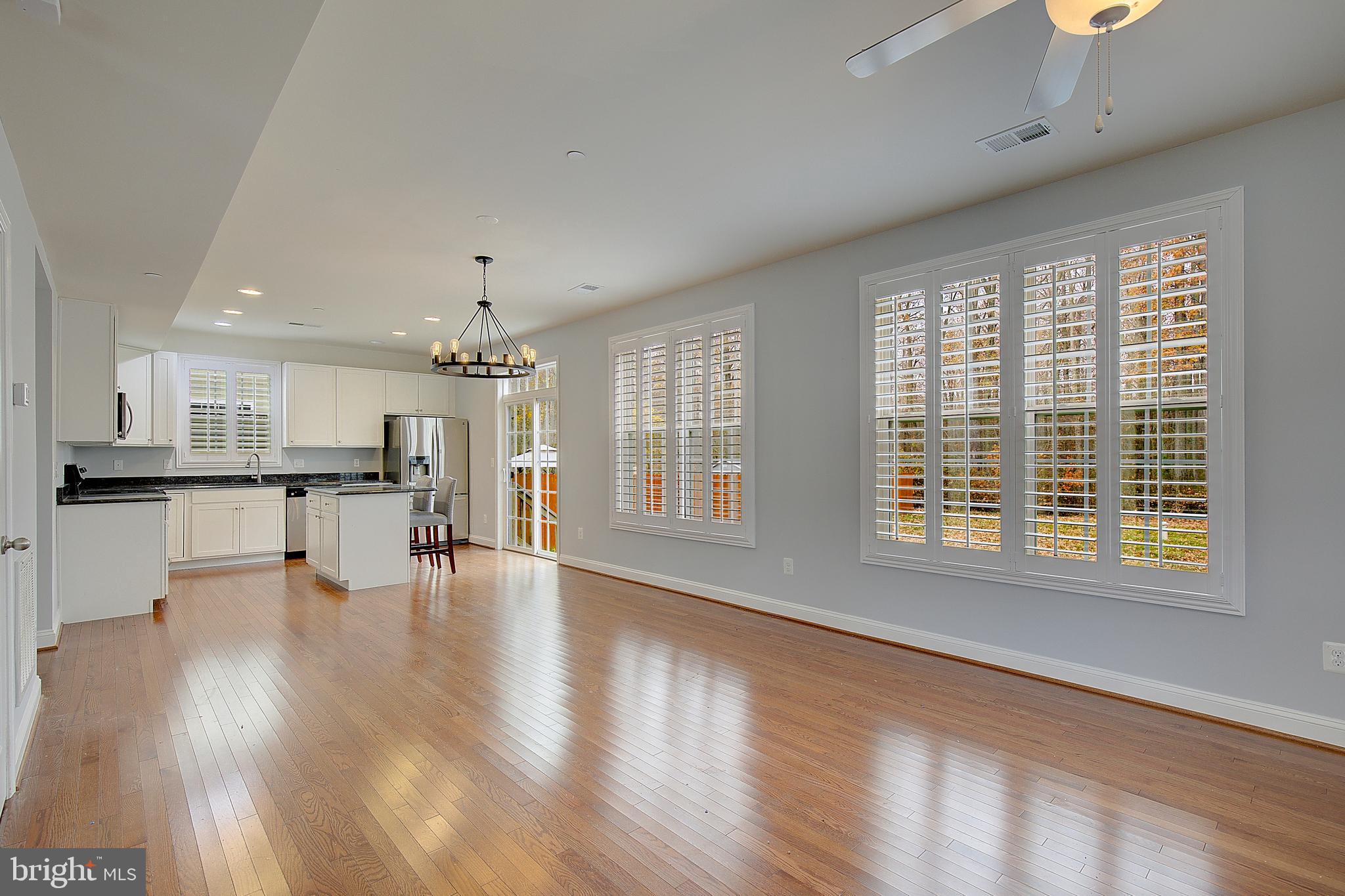 5952 Tyler Road Deale, MD 20751 - Photo 8 of 33 a view of an empty room with wooden floor and a kitchen