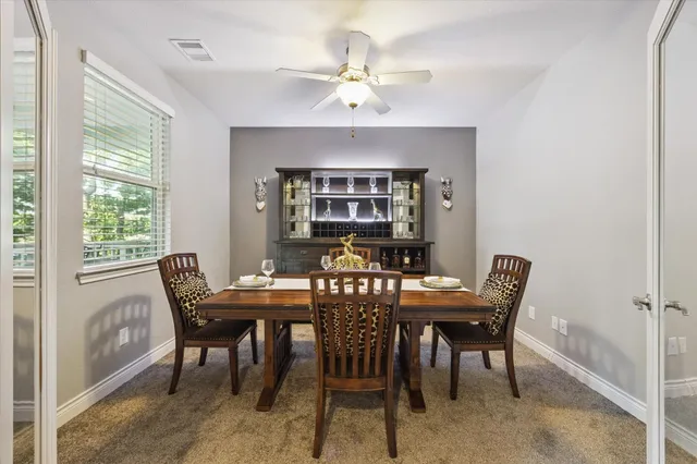 a bedroom with a bed mirror and couch