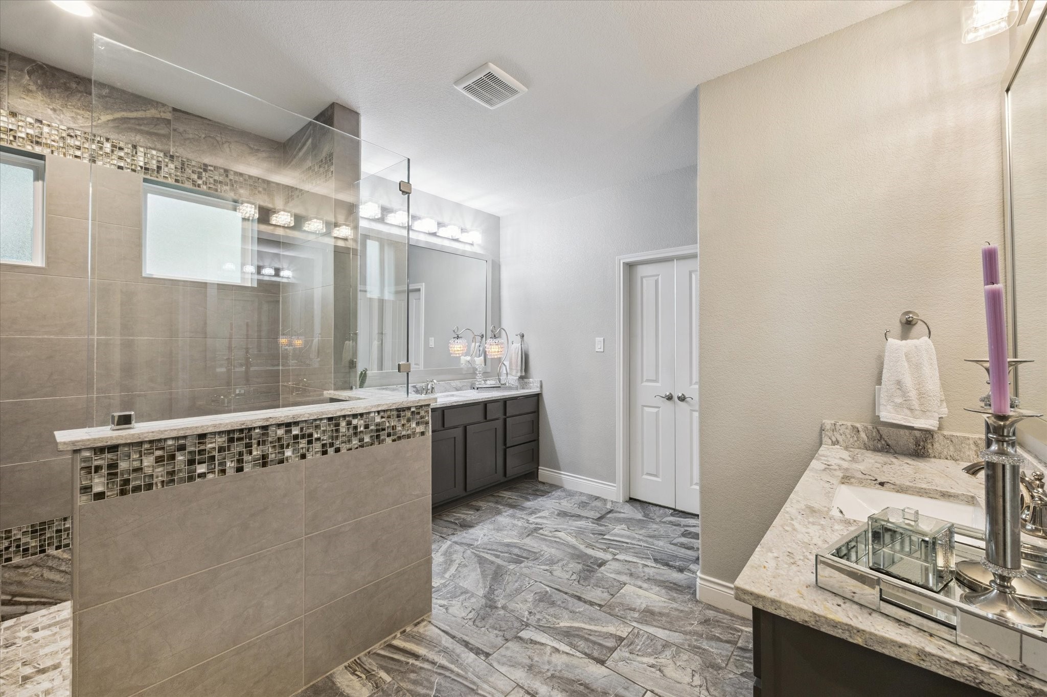 207 West 6th Street Kemah, TX 77565 - Photo 17 of 41 a spacious bathroom with a granite countertop sink a mirror and a bathtub