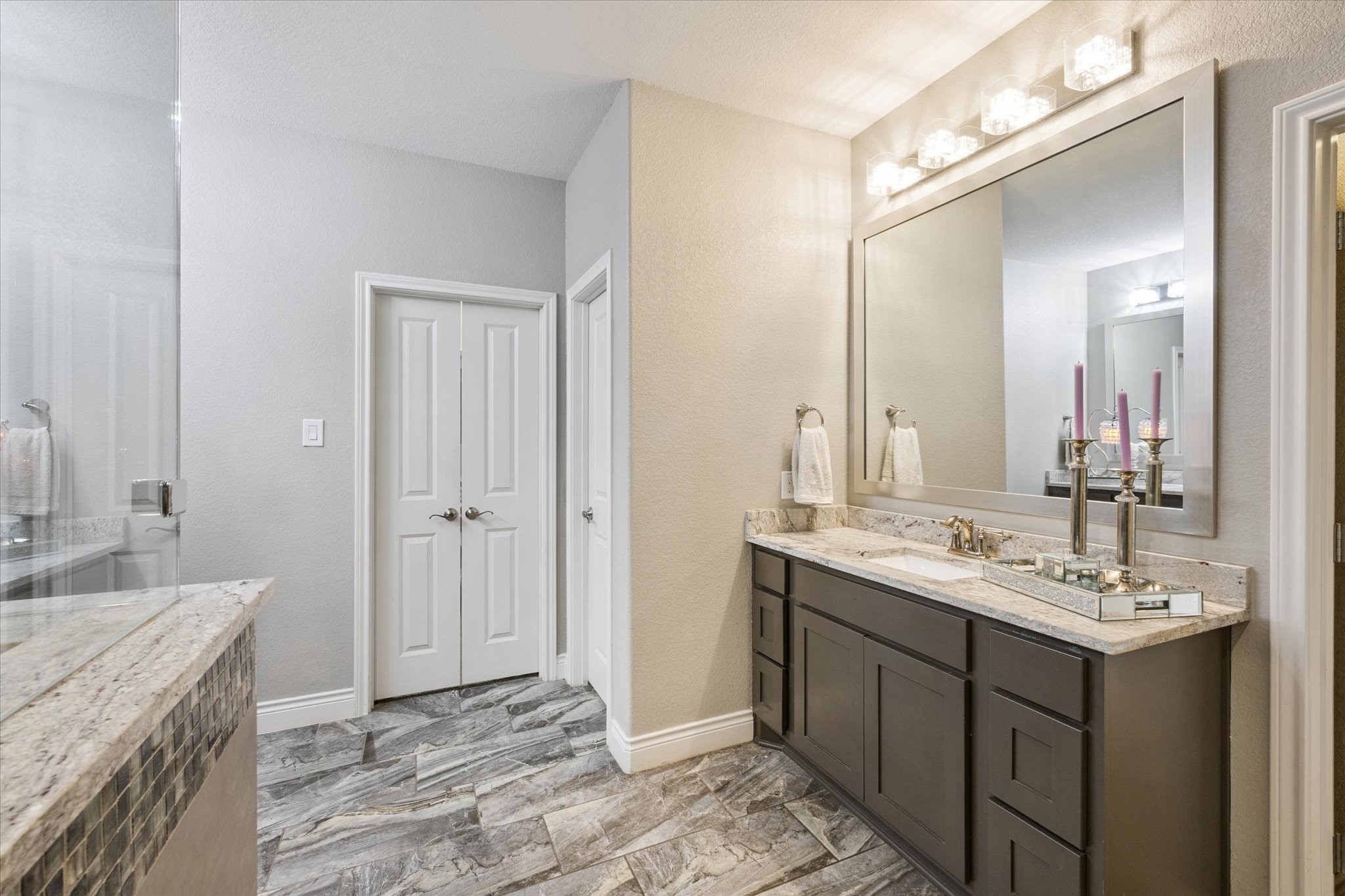 207 West 6th Street Kemah, TX 77565 - Photo 19 of 41 a bathroom with a sink double vanity and a mirror