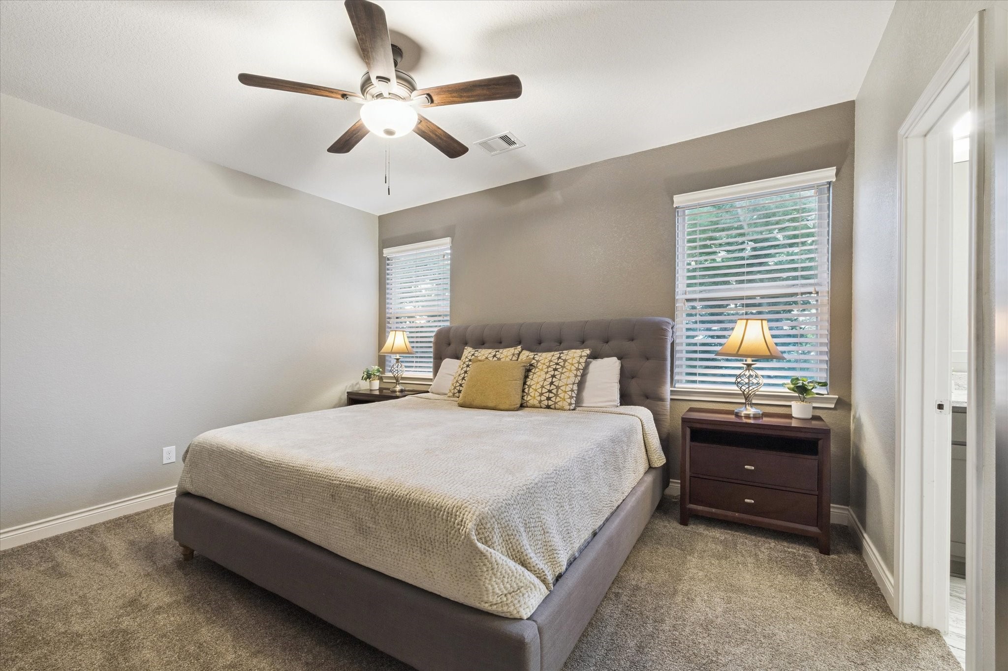 207 West 6th Street Kemah, TX 77565 - Photo 26 of 41 a bedroom with a bed and a chandelier