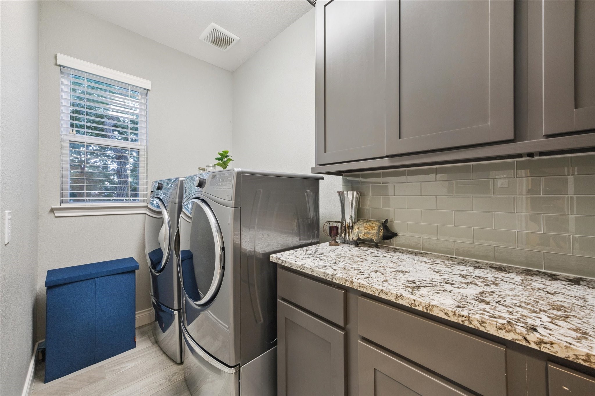207 West 6th Street Kemah, TX 77565 - Photo 28 of 41 a utility room with granite countertop a sink a washer and dryer