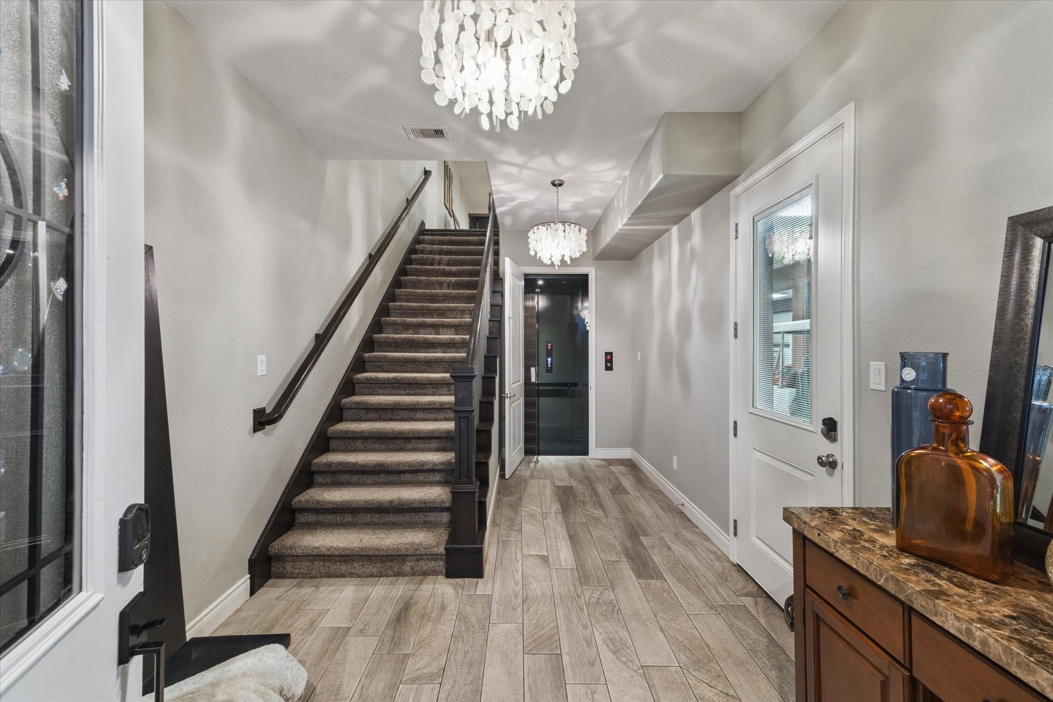207 West 6th Street Kemah, TX 77565 - Photo 4 of 41 Bright entry with wood-look floors, chandelier, and sleek staircase