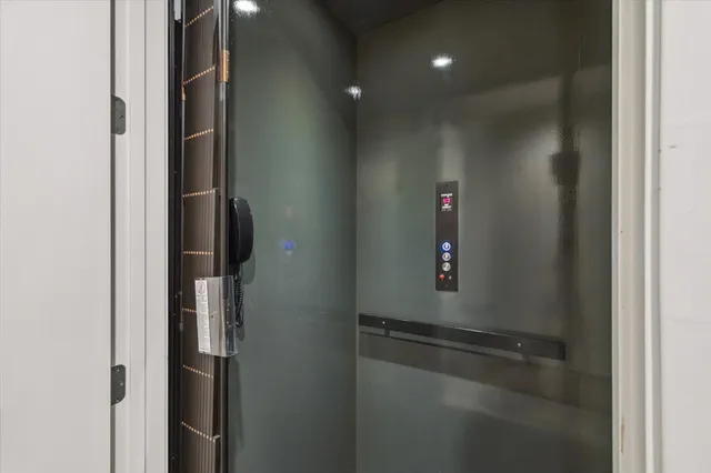 a kitchen with kitchen island granite countertop a sink cabinets and stainless steel appliances