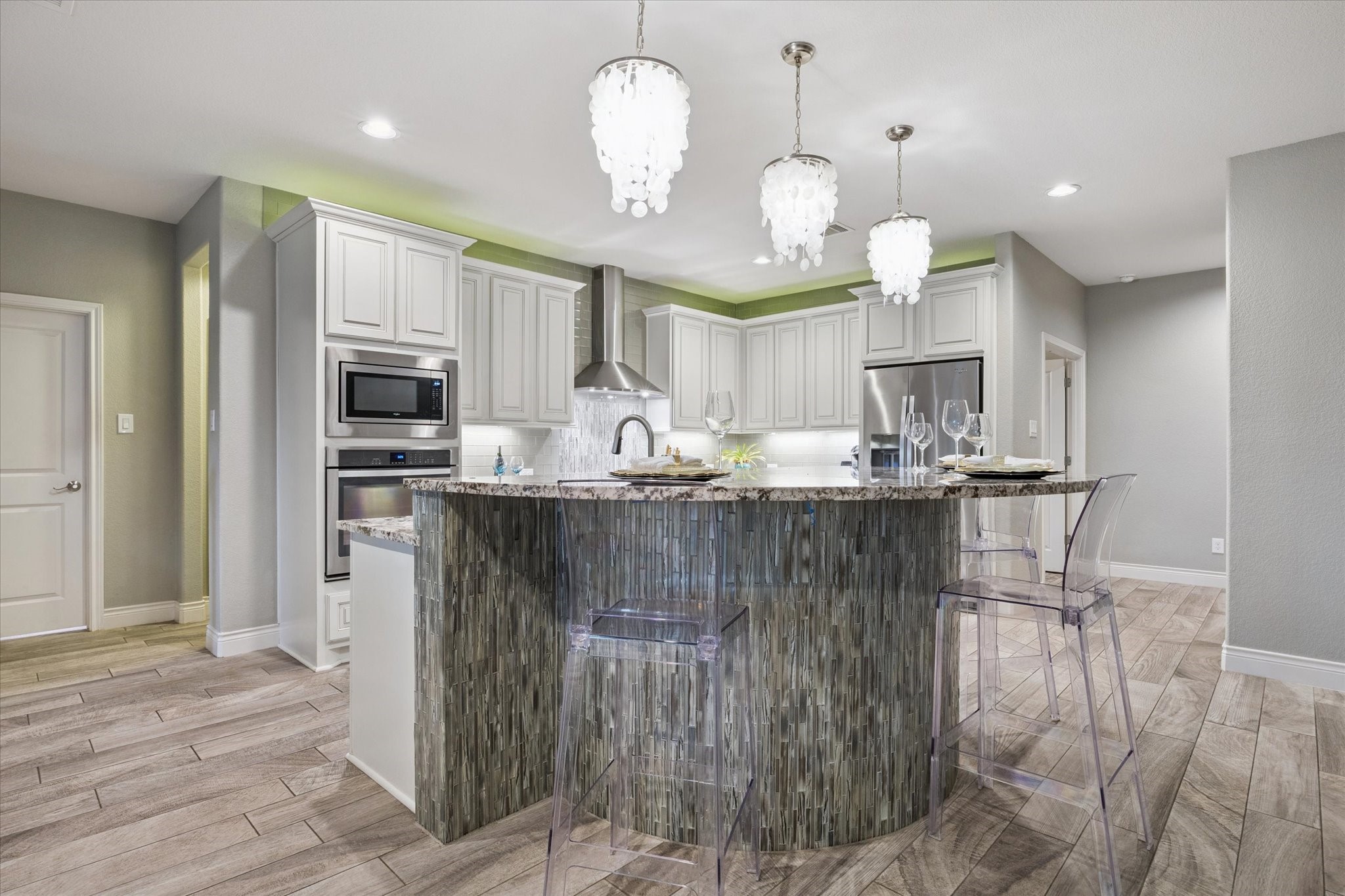 207 West 6th Street Kemah, TX 77565 - Photo 7 of 41 a kitchen with kitchen island granite countertop a sink cabinets and stainless steel appliances