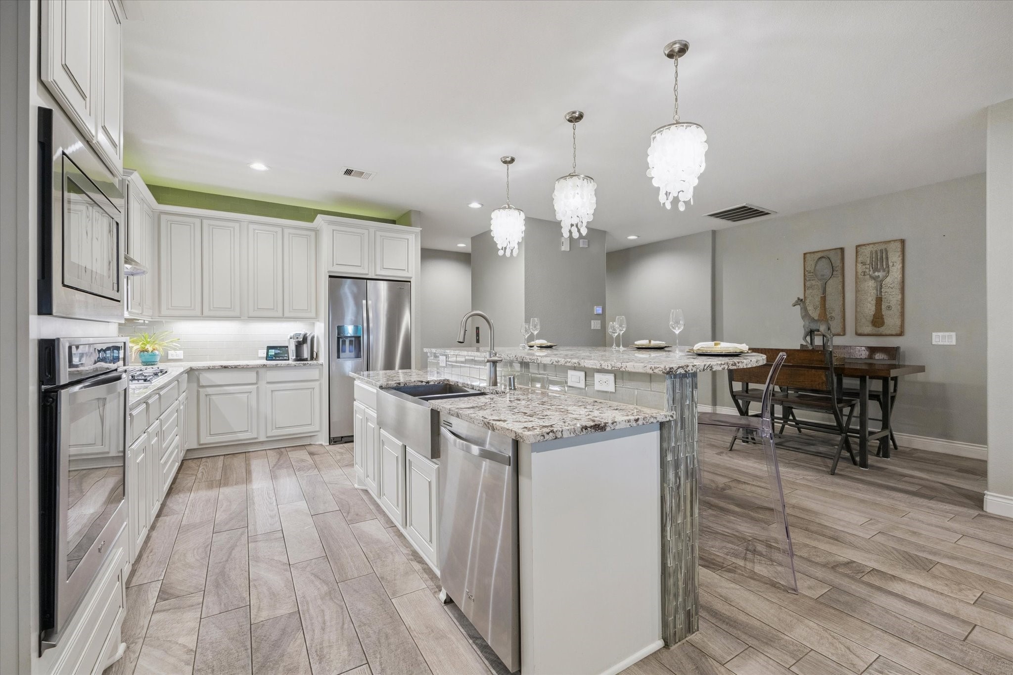 207 West 6th Street Kemah, TX 77565 - Photo 9 of 41 a kitchen with stainless steel appliances a stove a sink dishwasher a kitchen island with wooden cabinets and floor