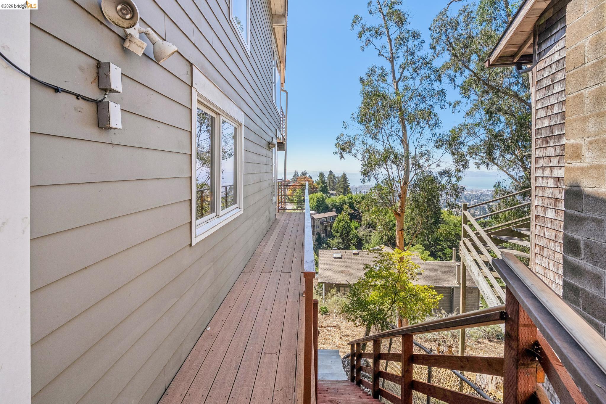 1394 Queens Road Berkeley, CA 94708 - Photo 60 of 63 Wood-finish deck with wood railings, siding exterior, and mature trees