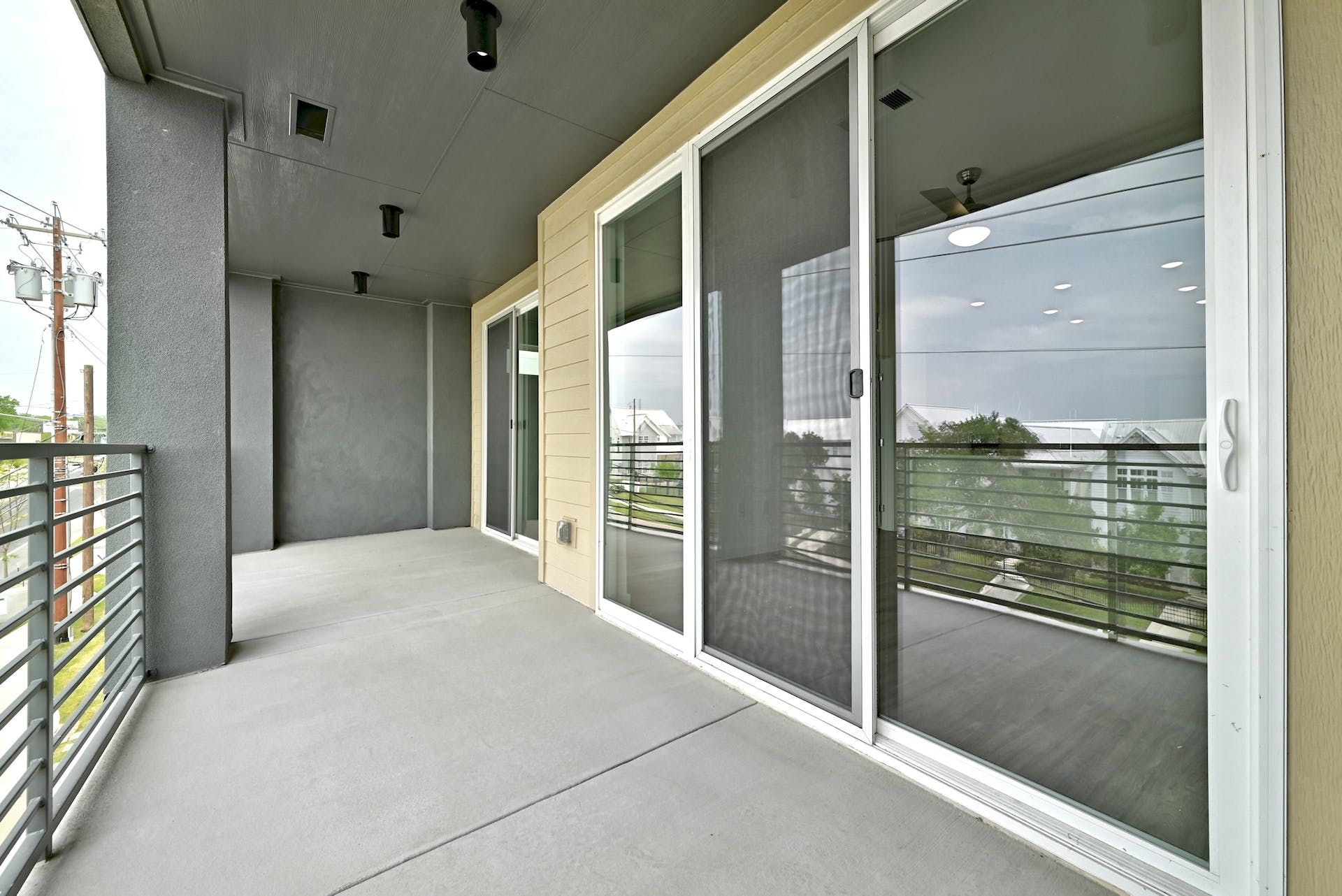 4801 Springdale Road, Unit 1301 Austin, TX 78723 - Photo 27 of 39 A spacious balcony extends living space with durable concrete flooring and modern railing.