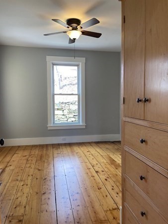 33 Ash Street Spencer, MA 01562 - Photo 12 of 37 a view of empty room with wooden floor and fan