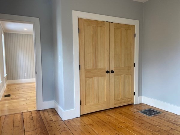33 Ash Street Spencer, MA 01562 - Photo 14 of 37 an empty room with wooden floor and closet area