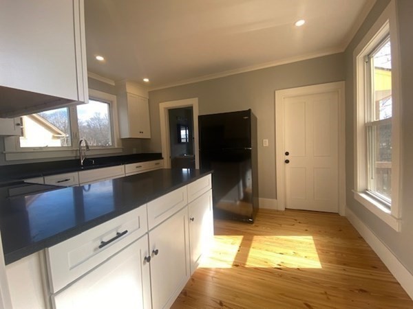 33 Ash Street Spencer, MA 01562 - Photo 17 of 37 a kitchen with stainless steel appliances granite countertop a sink and a stove top oven