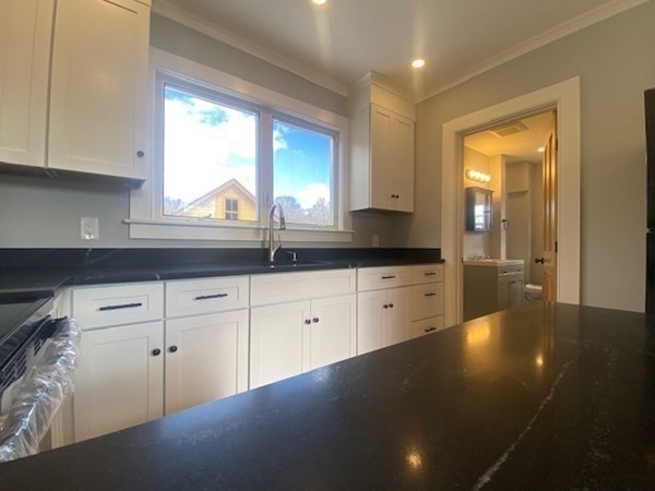 33 Ash Street Spencer, MA 01562 - Photo 18 of 37 a kitchen with granite countertop white cabinets and a window