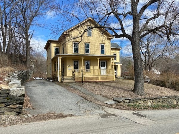 33 Ash Street Spencer, MA 01562 - Photo 2 of 37 a view of a large white house with a large tree