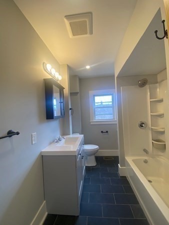 33 Ash Street Spencer, MA 01562 - Photo 21 of 37 a bathroom with a sink a toilet and bathtub