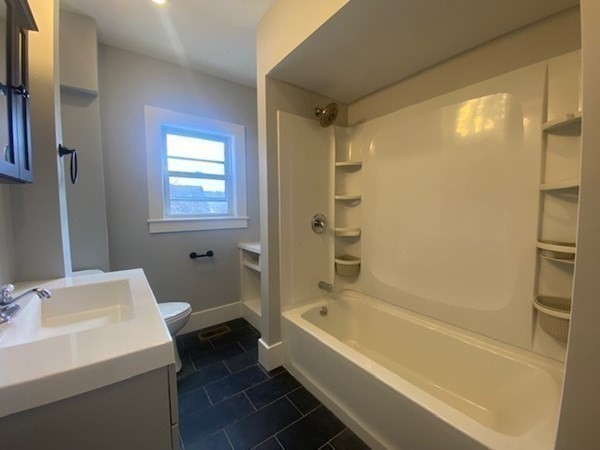 33 Ash Street Spencer, MA 01562 - Photo 22 of 37 a bathroom with a bathtub shower sink vanity and a toilet