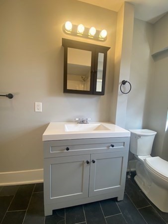 33 Ash Street Spencer, MA 01562 - Photo 24 of 37 a bathroom with a sink a toilet and mirror